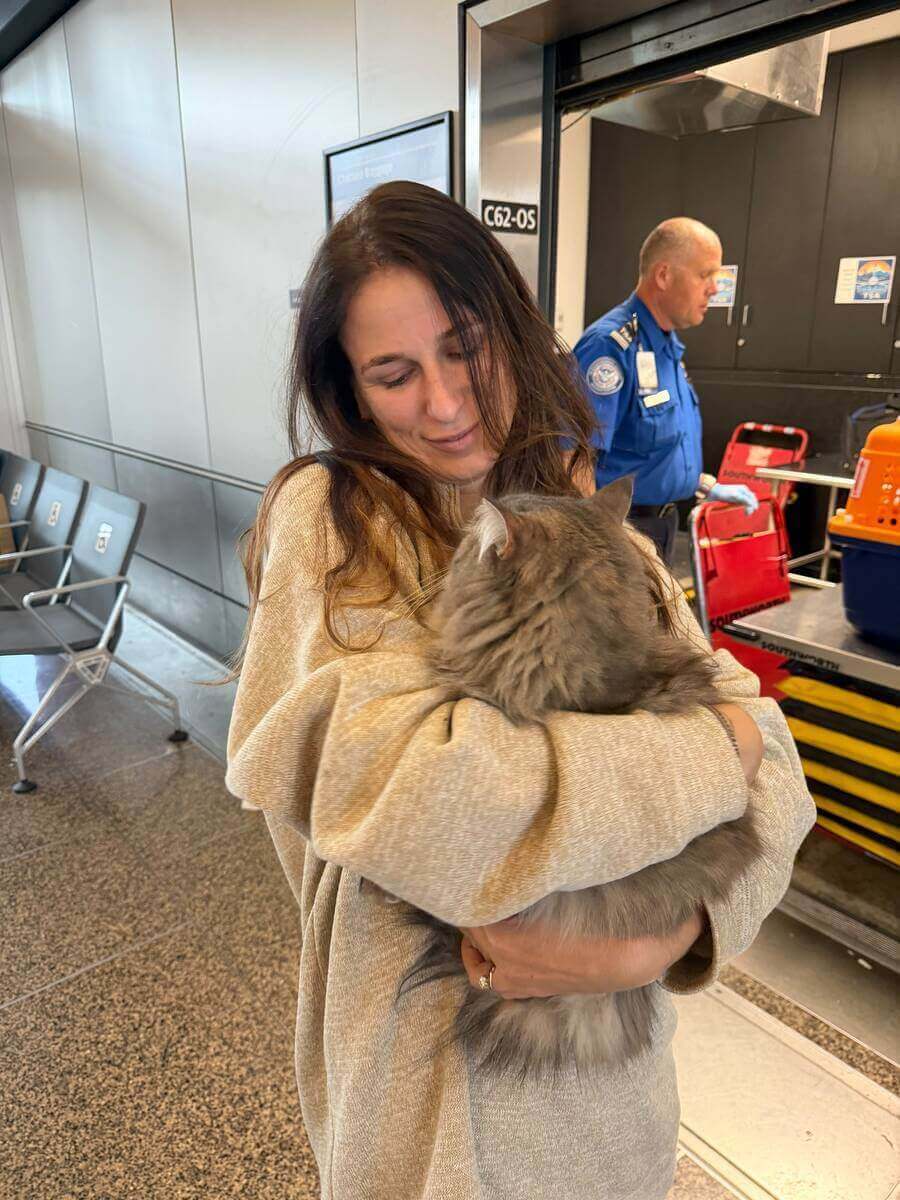 Across The Pond Pets team member at airport check-in with pet travel crates
