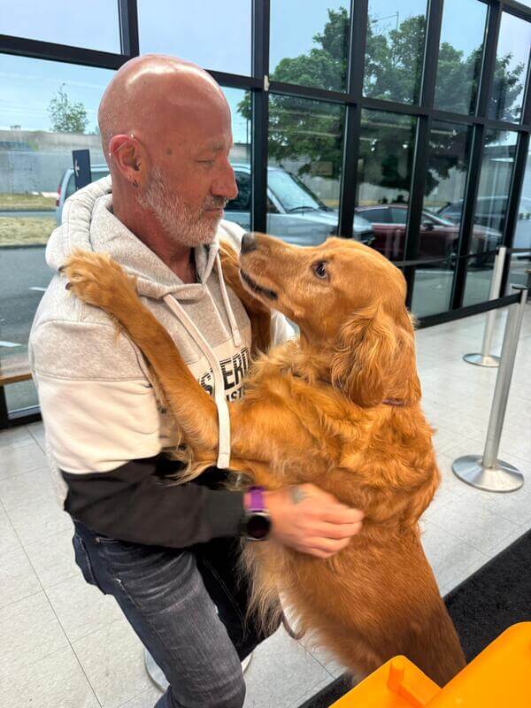 Tucker the dog with Across The Pond Pets transporter Robert at Seattle-Tacoma International Airport before his flight to Costa Rica