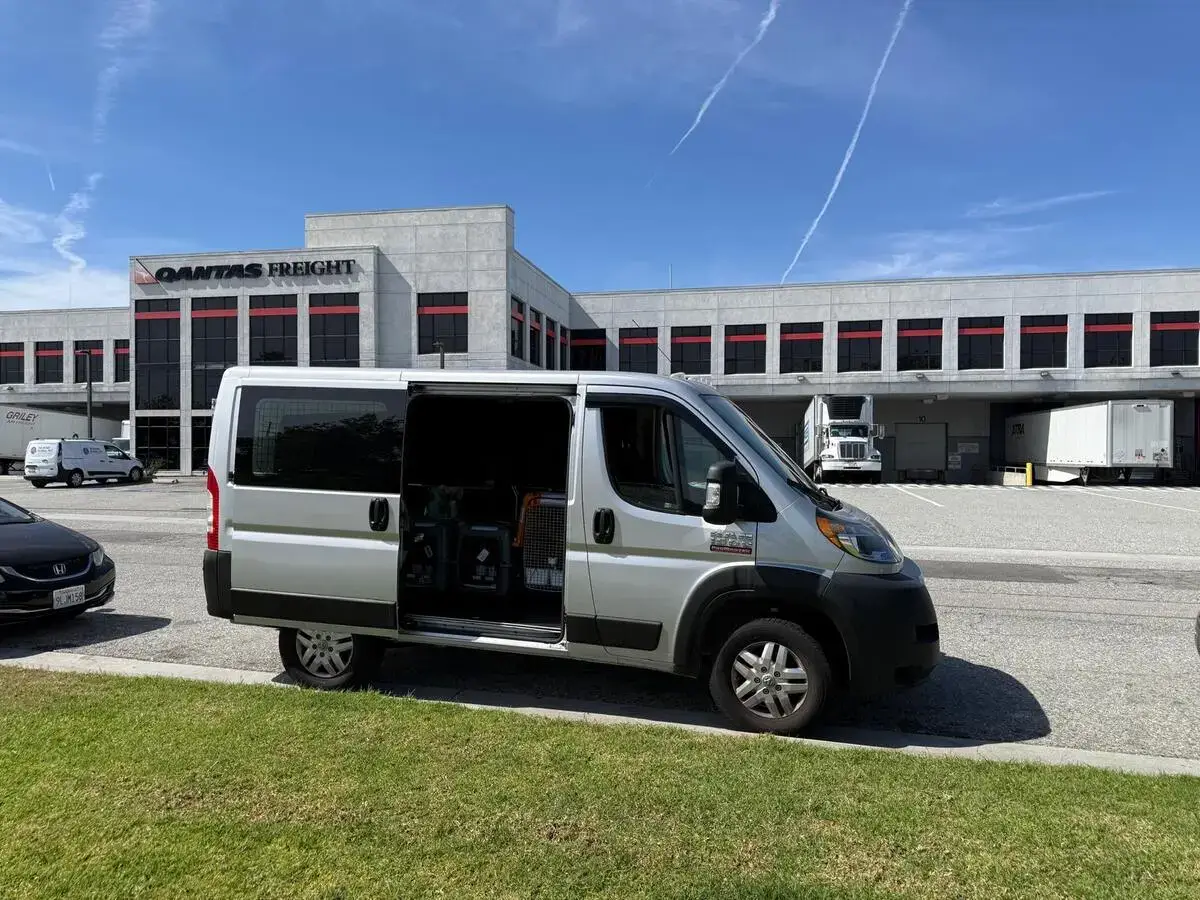 Across The Pond Pets transport van parked outside the Qantas Freight terminal at LAX